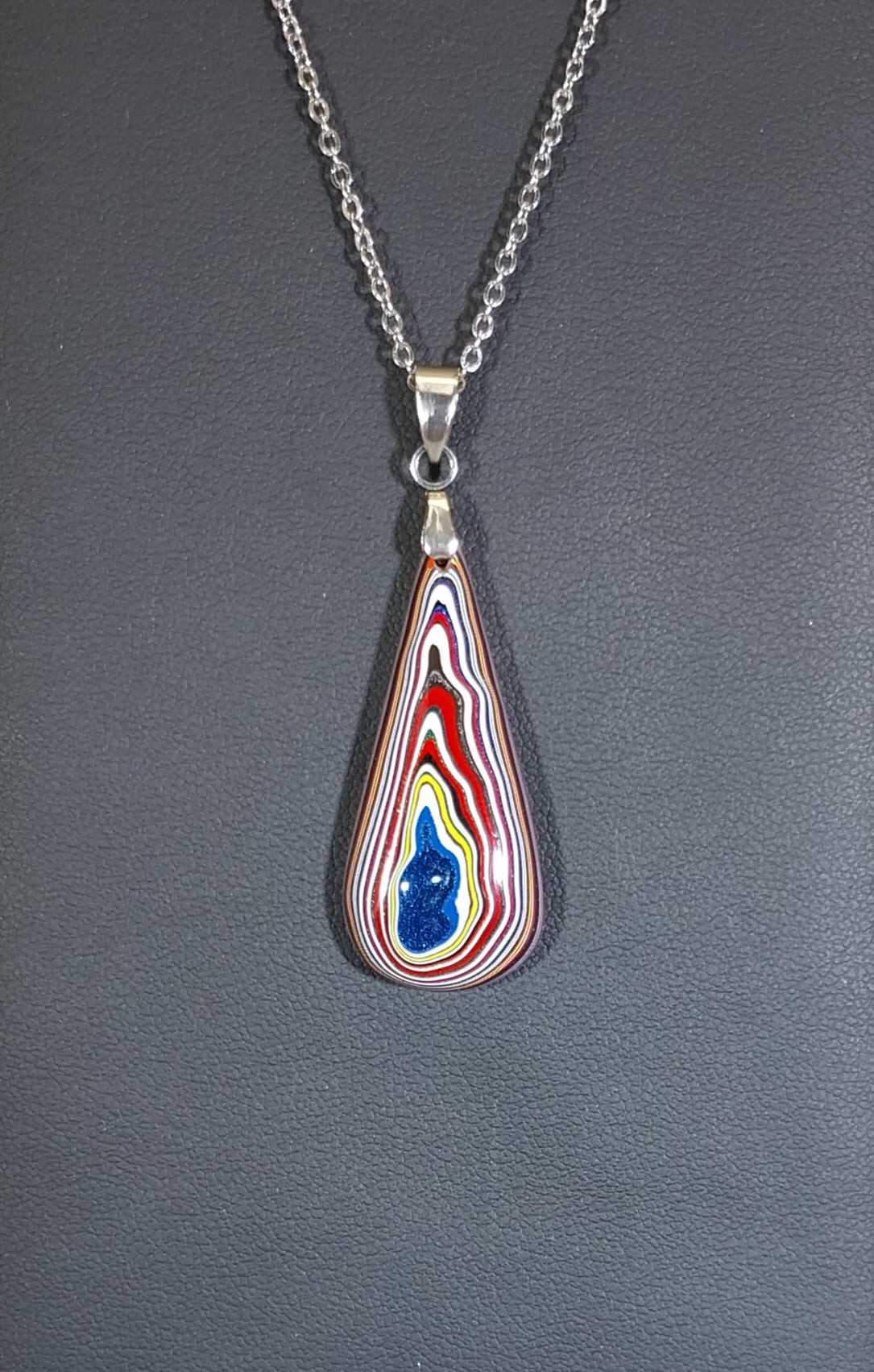 Fordite Necklace Lots of Red in an Elongated Teardrop