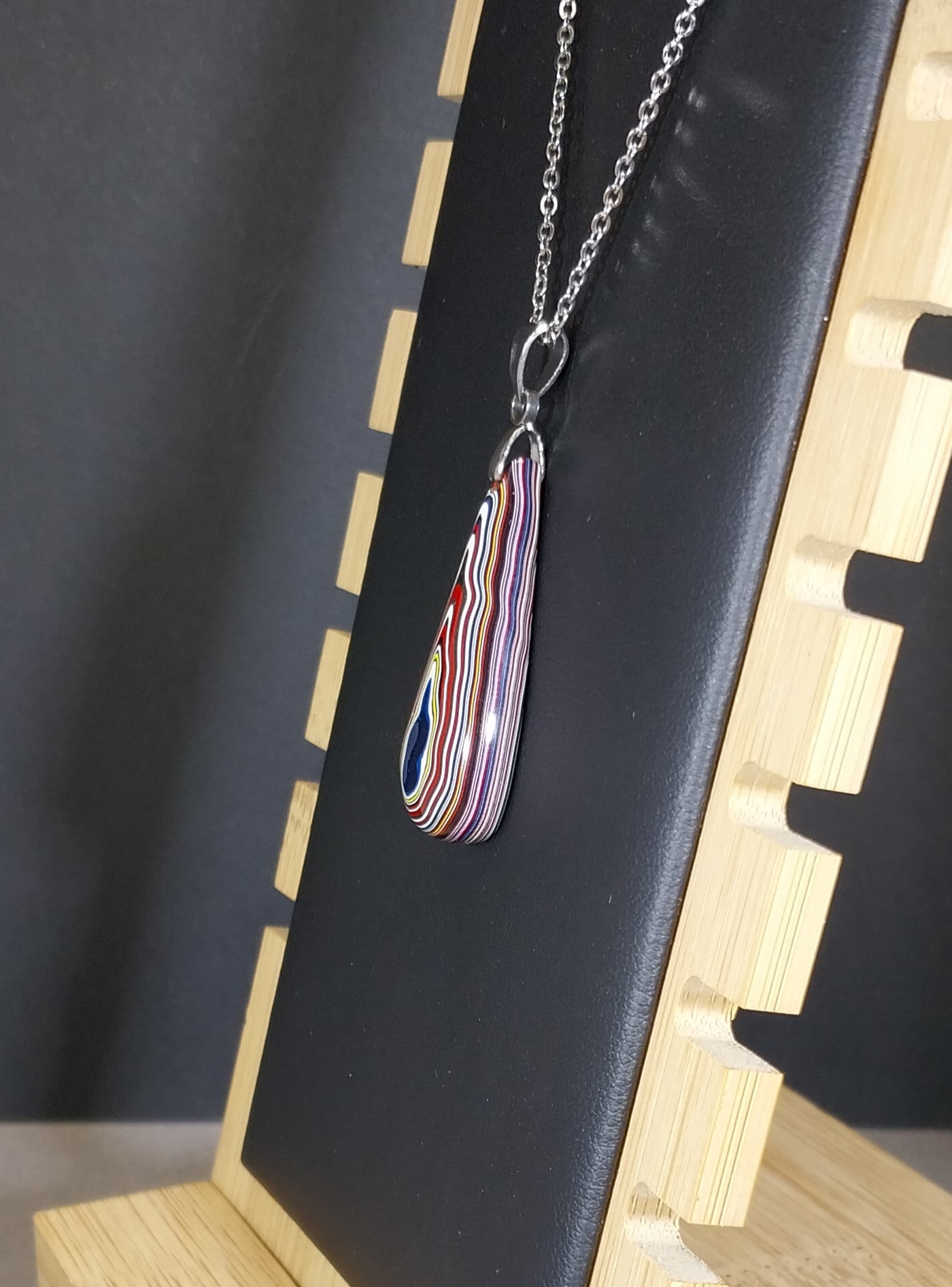 Fordite Necklace Lots of Red in an Elongated Teardrop