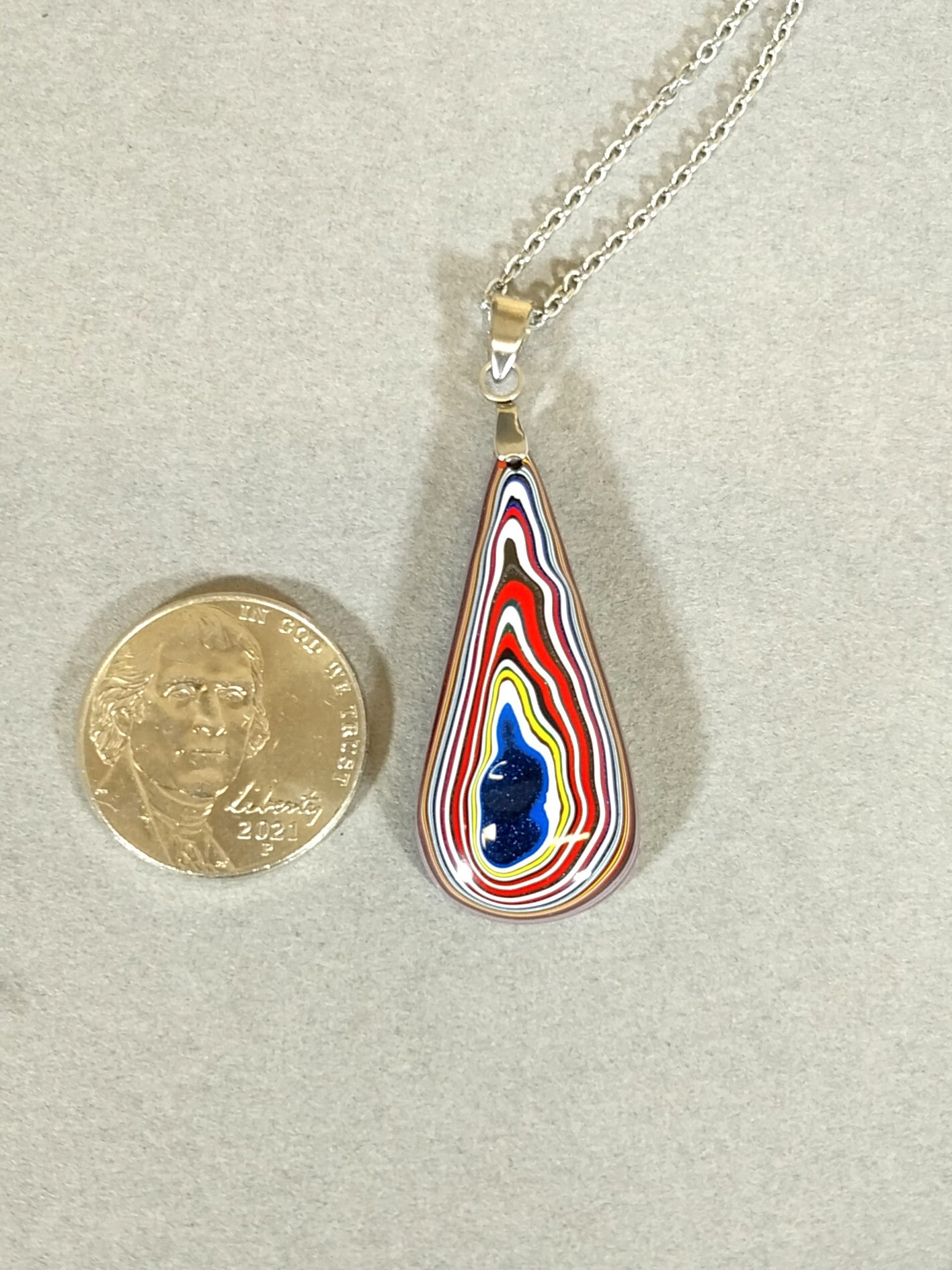 Fordite Necklace Lots of Red in an Elongated Teardrop