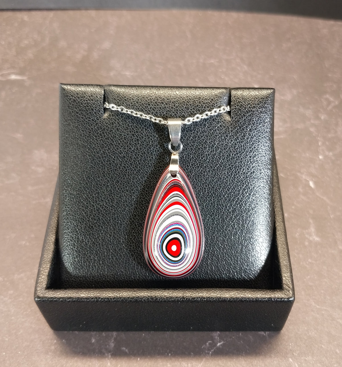 Fordite Necklace Great Colors in a Domed Teardrop